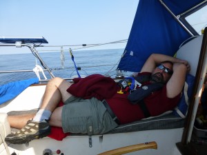 Adam Sleeping in Cockpit offshore